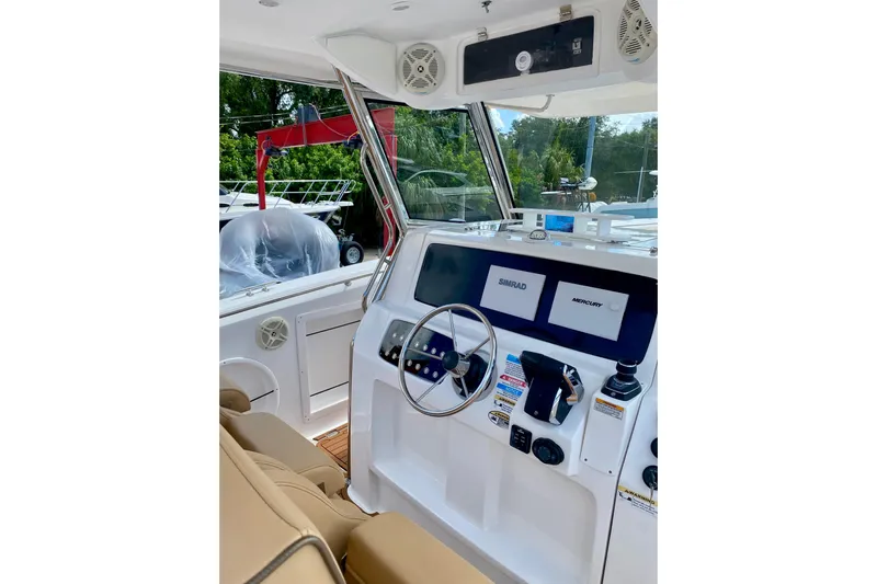  Yacht Photos Pics 2023 Fishing Raptor 390 Solarium boat cockpit with modern navigation equipment.