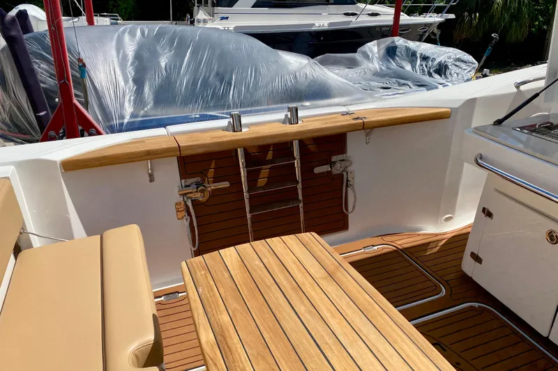  Yacht Photos Pics 2023 Fishing Raptor 390 Solarium boat interior with teak flooring and seating.