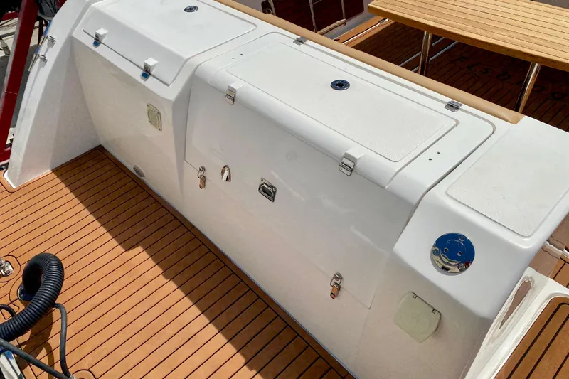  Yacht Photos Pics 2023 Fishing Raptor 390 Solarium boat deck with storage compartments and wooden flooring.