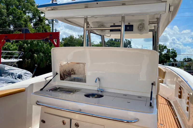  Yacht Photos Pics 2023 Fishing Raptor 390 Solarium boat with outdoor kitchen and sink.