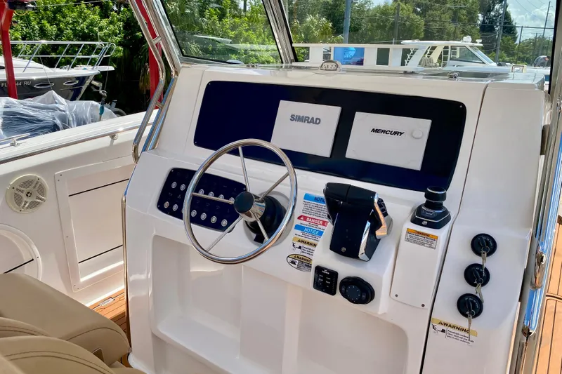  Yacht Photos Pics 2023 Fishing Raptor 390 Solarium boat dashboard with steering wheel and controls.