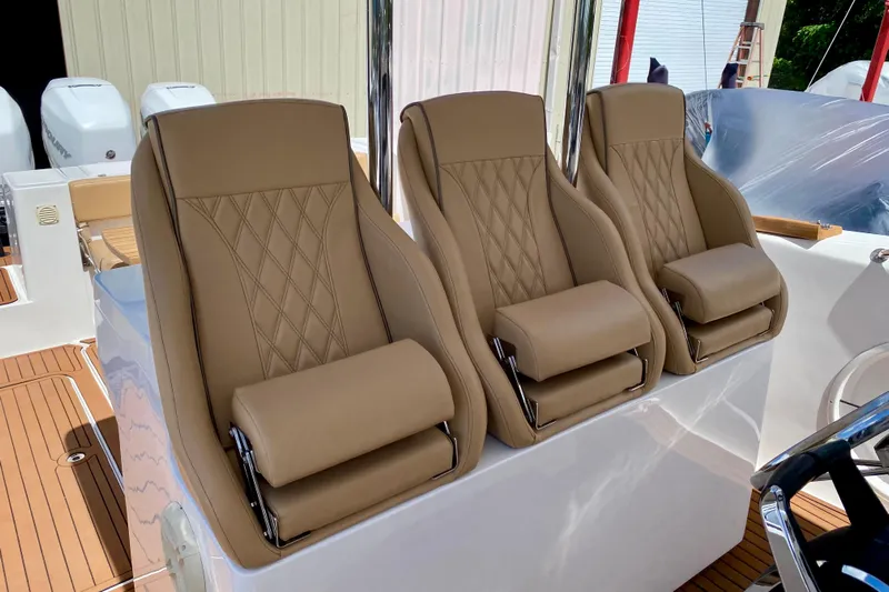  Yacht Photos Pics Luxury seating on 2023 Fishing Raptor 390 Solarium boat, featuring tan leather upholstery.