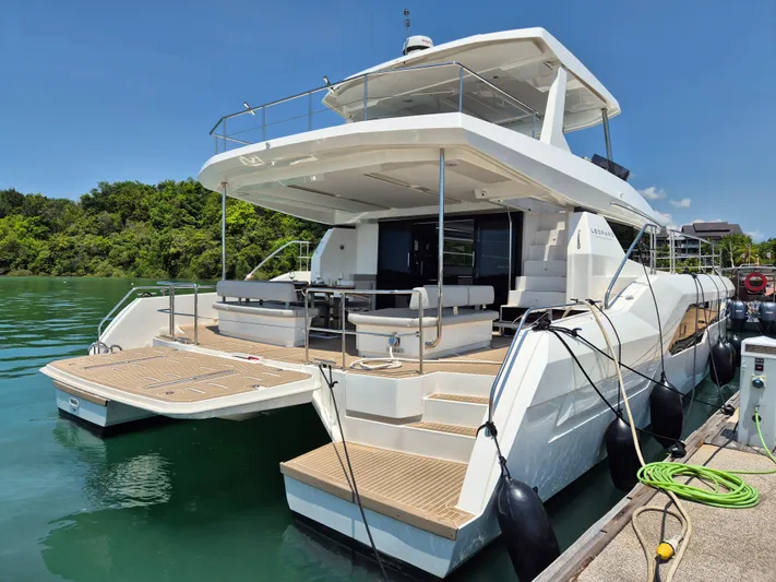  Yacht Photos Pics 2024 Leopard 53 Powercat yacht docked, showcasing spacious deck and modern design.