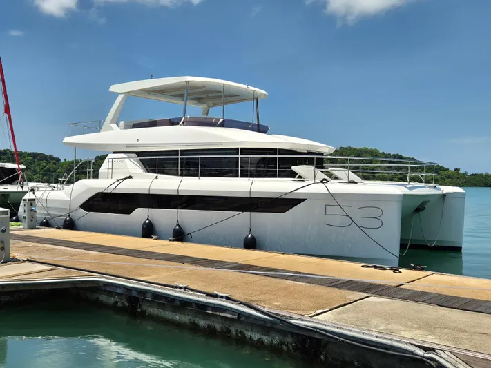  Yacht Photos Pics 2024 Leopard 53 Powercat yacht docked in a marina under a clear blue sky.