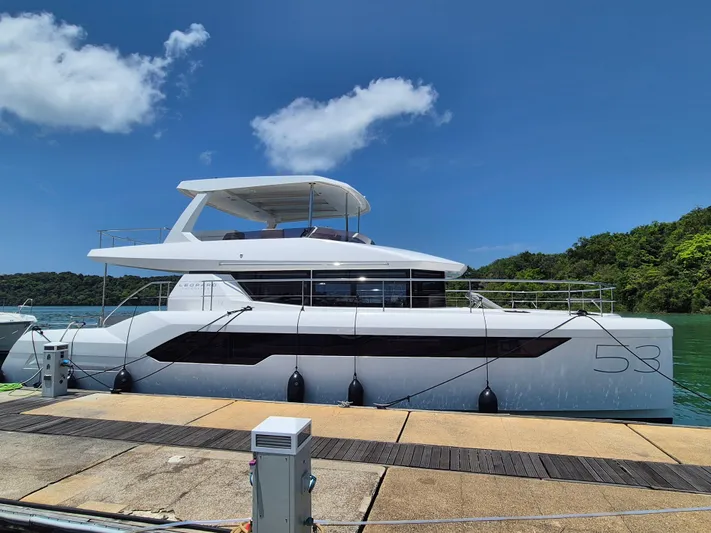  Yacht Photos Pics 2024 Leopard 53 Powercat yacht docked under clear blue sky.