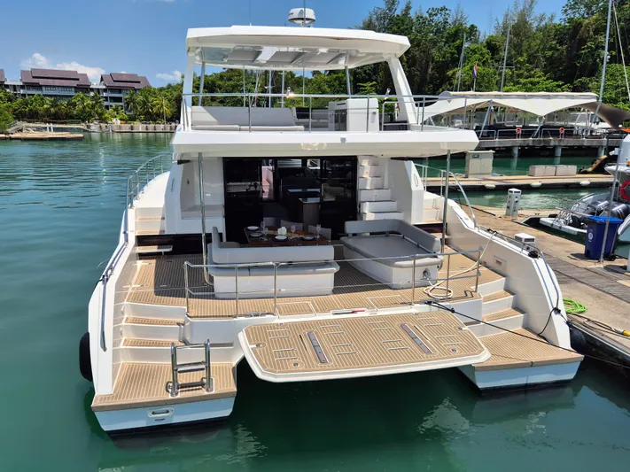  Yacht Photos Pics 2024 Leopard 53 Powercat yacht docked, featuring spacious deck and modern design.