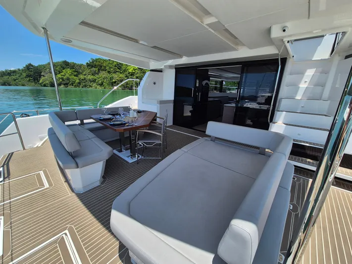  Yacht Photos Pics 2024 Leopard 53 Powercat yacht with spacious deck, elegant seating, and scenic water view.