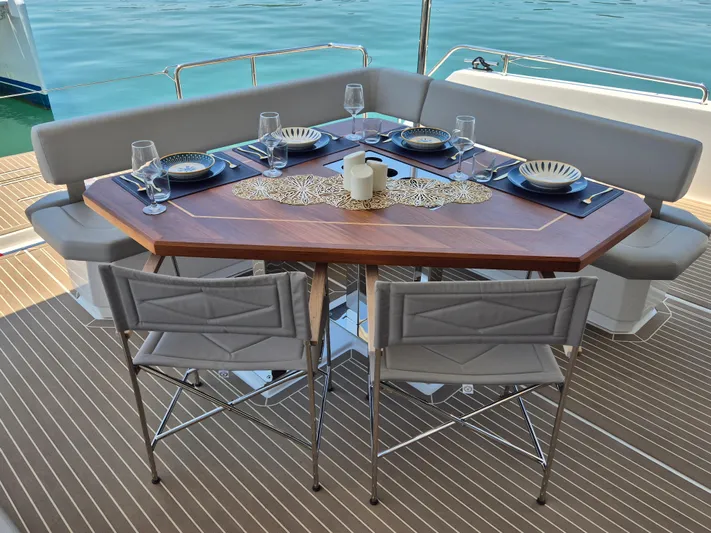  Yacht Photos Pics Elegant dining setup on 2024 Leopard 53 Powercat yacht, featuring a stylish table and ocean view.