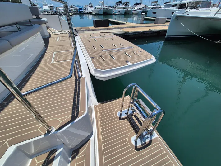  Yacht Photos Pics 2024 Leopard 53 Powercat yacht docked, featuring sleek deck design and stainless steel ladder.