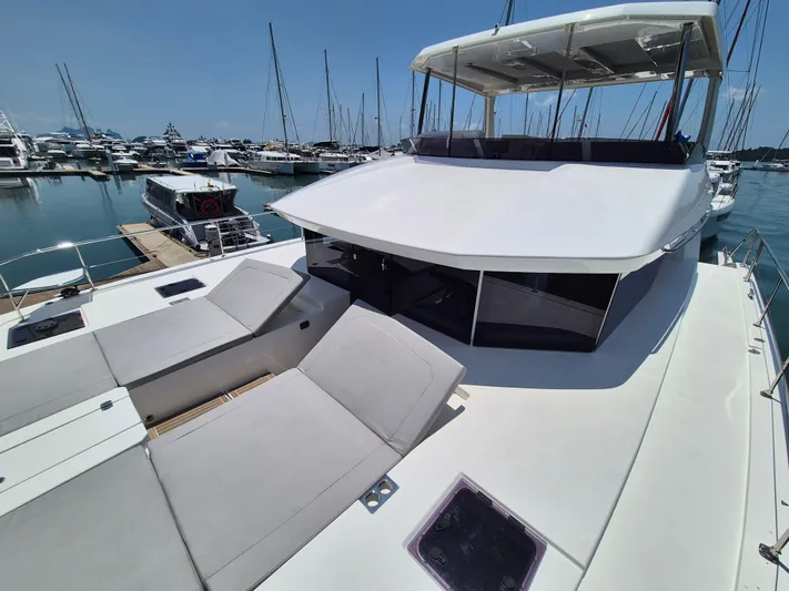  Yacht Photos Pics 2024 Leopard 53 Powercat yacht docked in marina, featuring spacious deck and modern design.