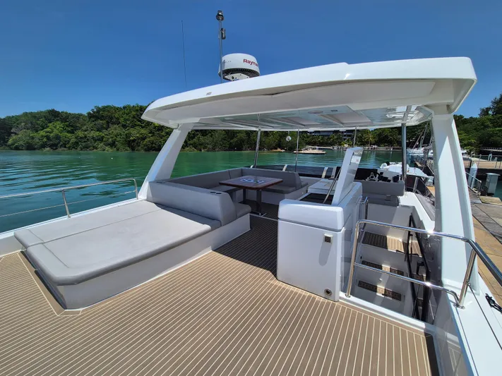  Yacht Photos Pics 2024 Leopard 53 Powercat yacht with spacious deck, modern seating, and scenic water view.