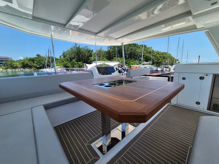  Yacht Photos Pics 2024 Leopard 53 Powercat yacht interior with sleek wooden table and comfortable seating.