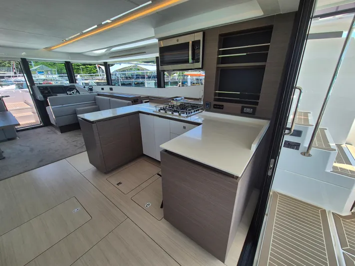  Yacht Photos Pics Modern kitchen interior of 2024 Leopard 53 Powercat yacht, featuring sleek countertops and ample natural light.