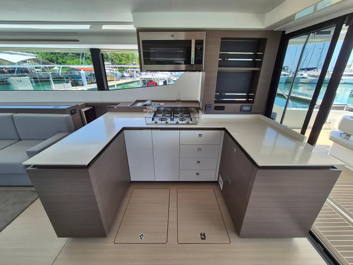  Yacht Photos Pics Modern kitchen interior on 2024 Leopard 53 Powercat yacht, featuring sleek countertops and appliances.