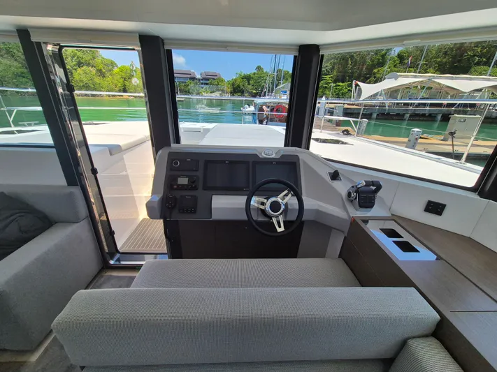  Yacht Photos Pics 2024 Leopard 53 Powercat helm with modern controls and panoramic marina view.