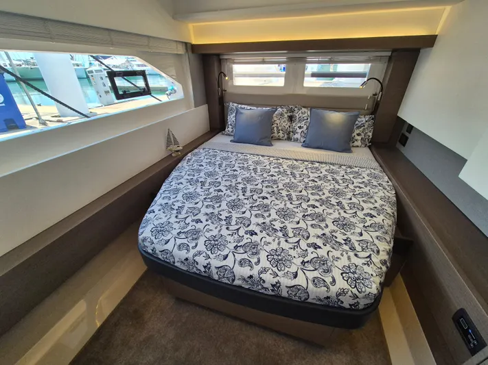  Yacht Photos Pics Luxurious bedroom interior of 2024 Leopard 53 Powercat with patterned bedding and modern design.