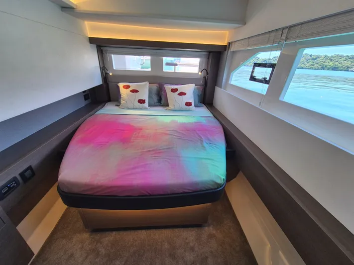  Yacht Photos Pics Luxurious bedroom interior of 2024 Leopard 53 Powercat with colorful bedding and scenic window view.