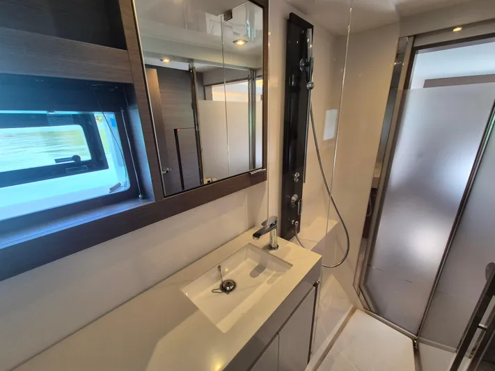  Yacht Photos Pics Modern bathroom in 2024 Leopard 53 Powercat yacht with sleek fixtures and frosted glass shower.