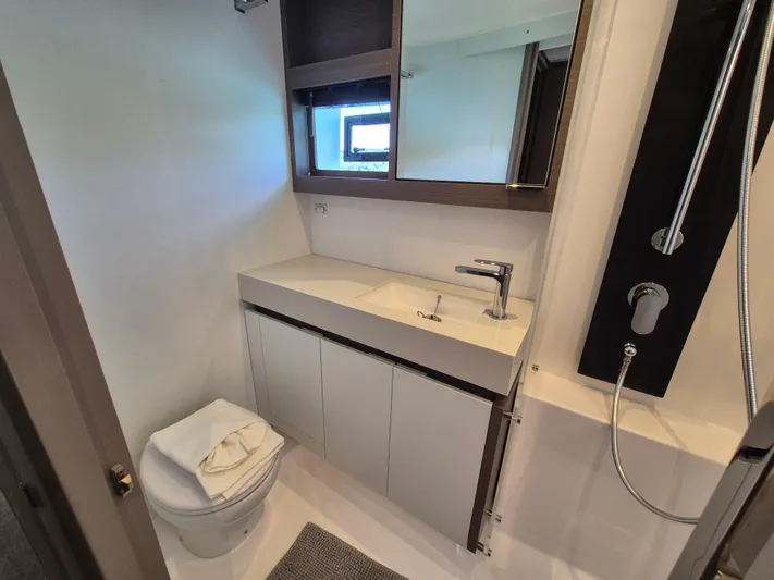  Yacht Photos Pics 2024 Leopard 53 Powercat bathroom with modern fixtures, sink, and shower.