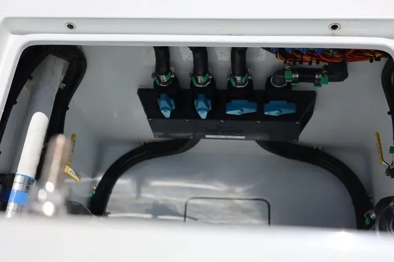  Yacht Photos Pics 2025 Contender 39 ST boat compartment with hoses and valves, showcasing internal components.