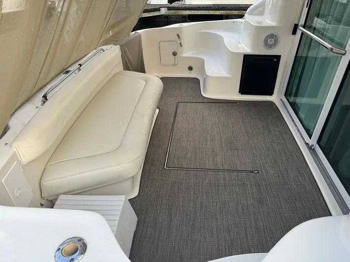 Messing About Yacht Photos Pics 2003 Sea Ray 400 Sedan Bridge interior with seating and carpeted floor.