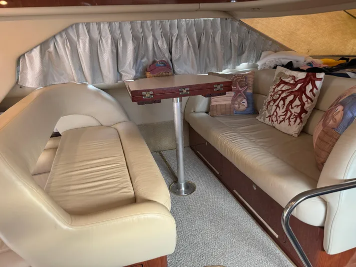 Messing About Yacht Photos Pics Luxurious interior of 2003 Sea Ray 400 Sedan Bridge with plush seating and decorative pillows.