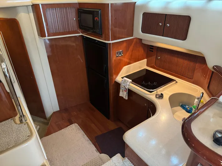 Messing About Yacht Photos Pics 2003 Sea Ray 400 Sedan Bridge yacht kitchen with wood cabinetry and modern appliances.