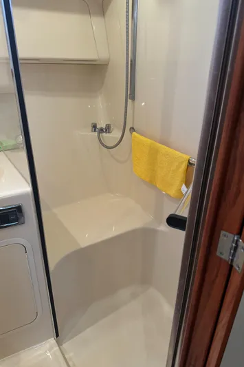 Messing About Yacht Photos Pics Shower area in 2003 Sea Ray 400 Sedan Bridge yacht with yellow towel.