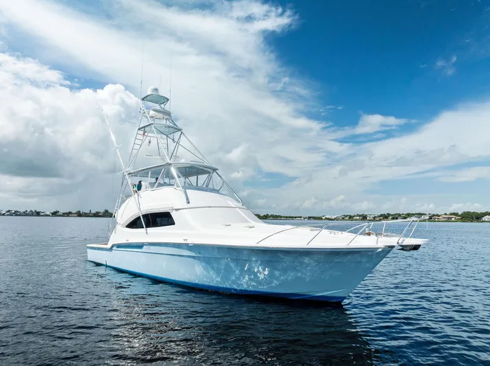 Sonny Boy Yacht Photos Pics 2004 Bertram 570 yacht on calm water under a partly cloudy sky.