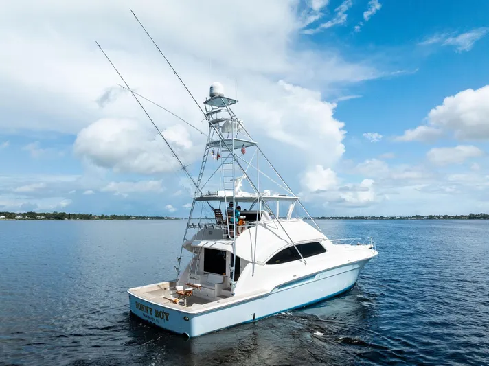 Sonny Boy Yacht Photos Pics 2004 Bertram 570 yacht on calm waters under a clear blue sky.