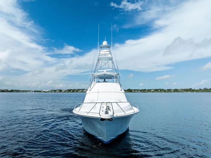 Sonny Boy Yacht Photos Pics 2004 Bertram 570 yacht on calm water under a clear blue sky.