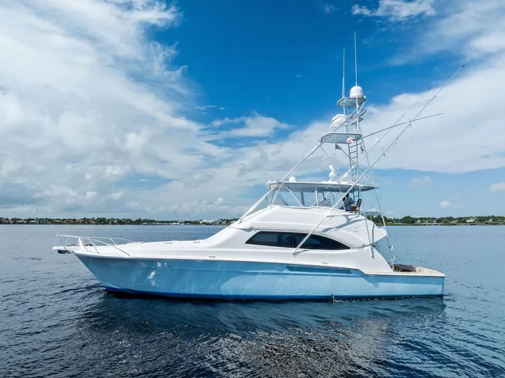 Sonny Boy Yacht Photos Pics 2004 Bertram 570 yacht on calm water under a clear blue sky.