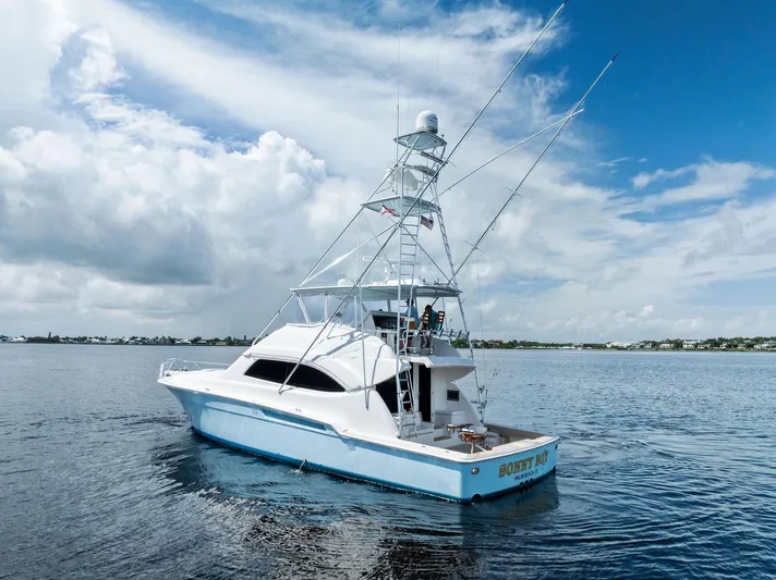 Sonny Boy Yacht Photos Pics 2004 Bertram 570 yacht on calm waters under a partly cloudy sky.