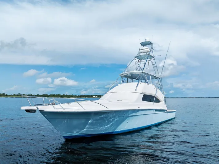 Sonny Boy Yacht Photos Pics 2004 Bertram 570 yacht on calm blue waters under a partly cloudy sky.