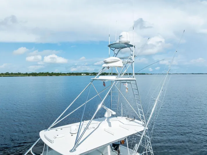 Sonny Boy Yacht Photos Pics 2004 Bertram 570 yacht with tower on calm water under blue sky.