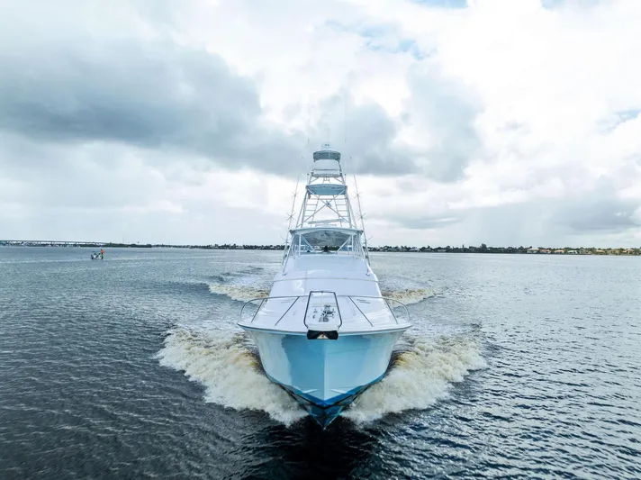 Sonny Boy Yacht Photos Pics Front view of a 2004 Bertram 570 yacht cruising on open water under cloudy skies.