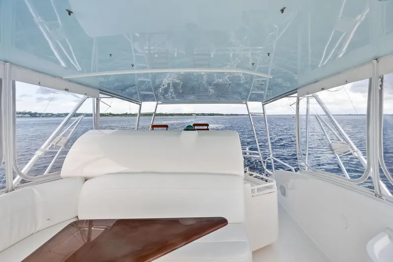 Sonny Boy Yacht Photos Pics Interior view of 2004 Bertram 570 yacht with white seating and ocean backdrop.