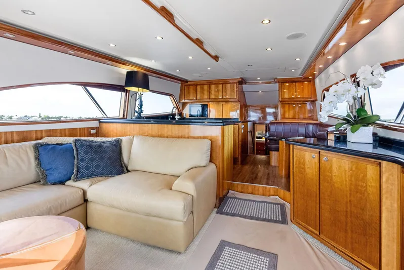 Sonny Boy Yacht Photos Pics Luxurious interior of 2004 Bertram 570 yacht with elegant wood finishes and plush seating.