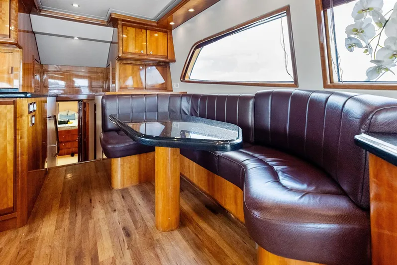 Sonny Boy Yacht Photos Pics Luxurious interior of 2004 Bertram 570 yacht with leather seating and wooden finishes.