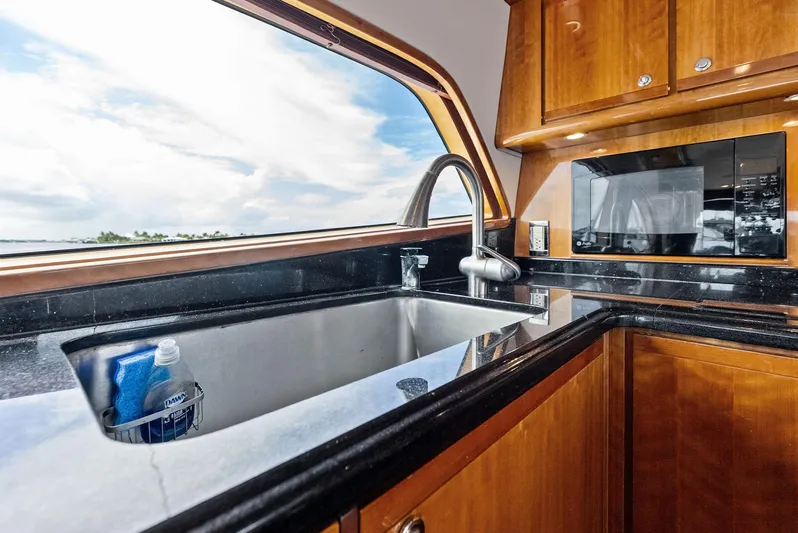 Sonny Boy Yacht Photos Pics Luxurious kitchen interior of 2004 Bertram 570 yacht with modern amenities.