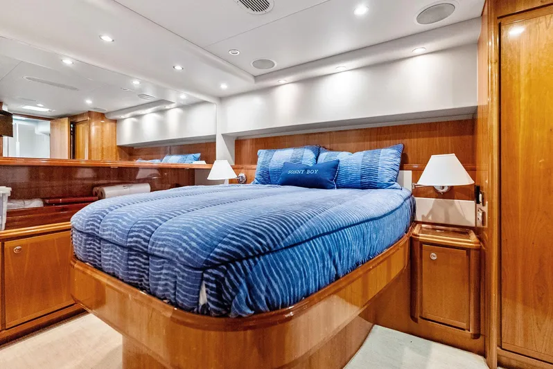 Sonny Boy Yacht Photos Pics Luxurious cabin interior of a 2004 Bertram 570 yacht with blue bedding and wooden finishes.