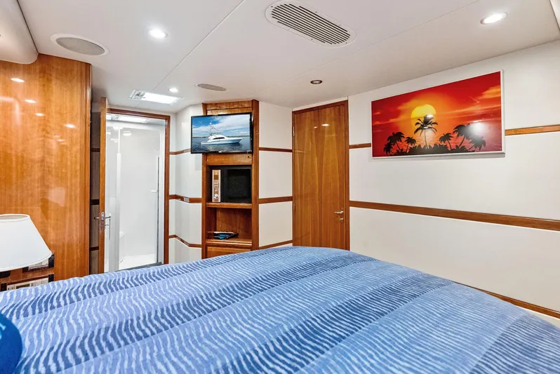 Sonny Boy Yacht Photos Pics Luxurious 2004 Bertram 570 yacht bedroom with modern decor and vibrant sunset artwork.