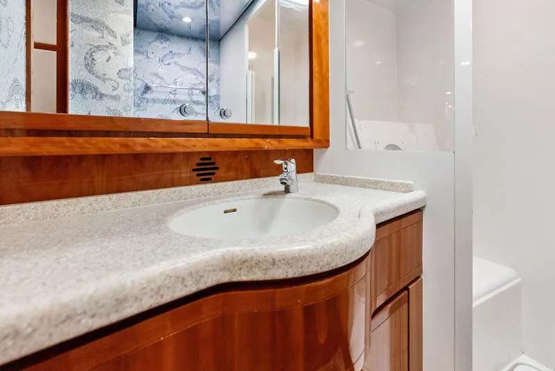 Sonny Boy Yacht Photos Pics Luxurious bathroom in 2004 Bertram 570 yacht with elegant wood cabinetry and modern fixtures.