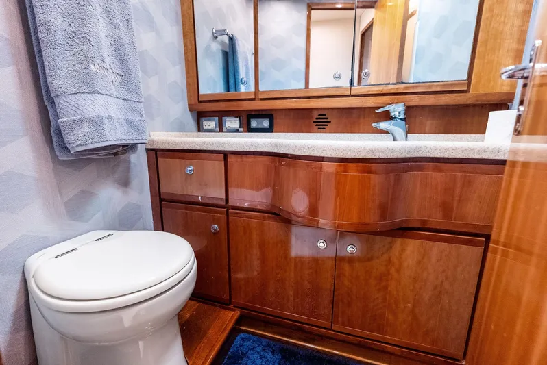 Sonny Boy Yacht Photos Pics Luxurious bathroom in 2004 Bertram 570 yacht with wooden cabinetry and modern fixtures.