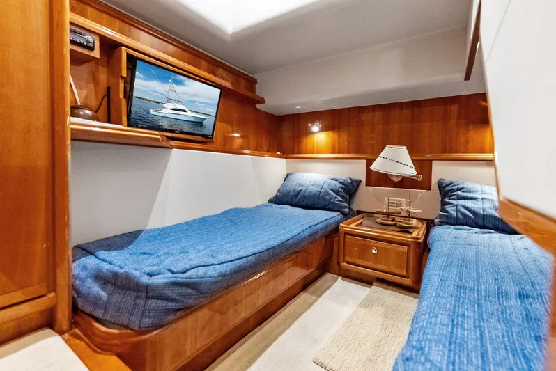 Sonny Boy Yacht Photos Pics Luxurious cabin interior of a 2004 Bertram 570 yacht with twin beds and wooden furnishings.