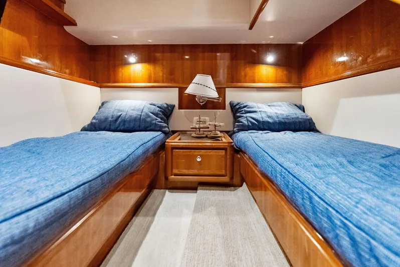 Sonny Boy Yacht Photos Pics Luxurious twin cabin in 2004 Bertram 570 yacht with blue bedding and wooden finishes.