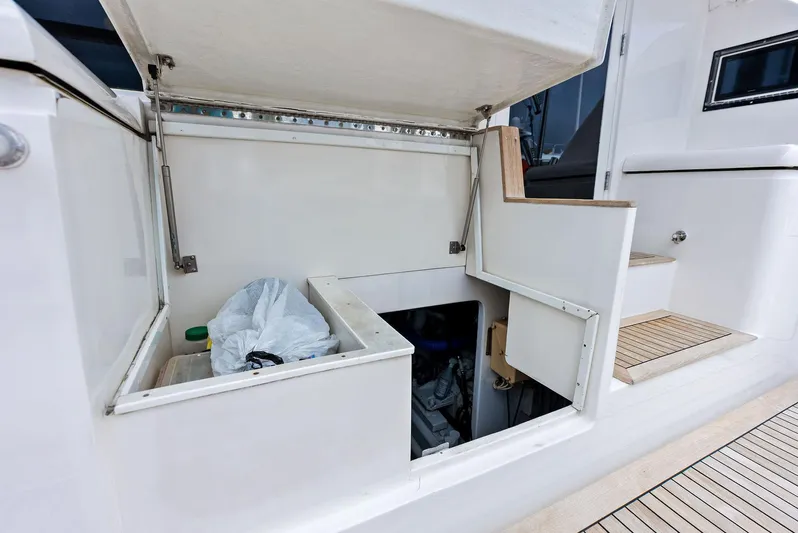 Sonny Boy Yacht Photos Pics 2004 Bertram 570 yacht storage compartment with open hatch and visible engine access.