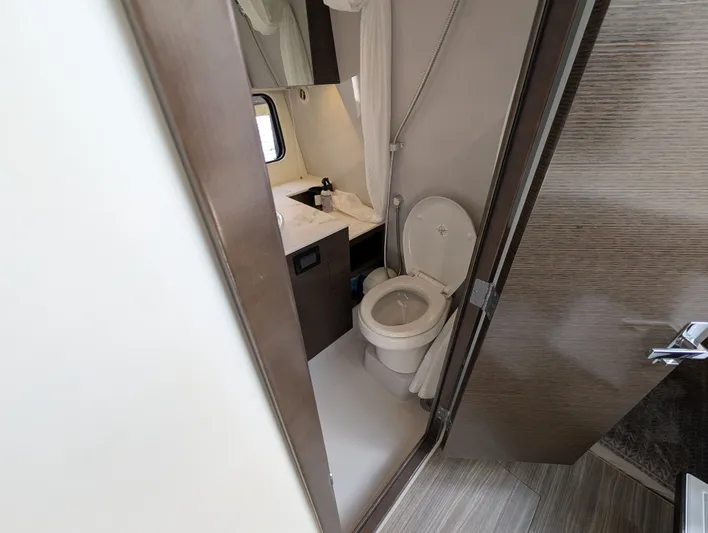  Yacht Photos Pics 2021 Cruisers Yachts 38 GLS bathroom with modern fixtures and compact design.