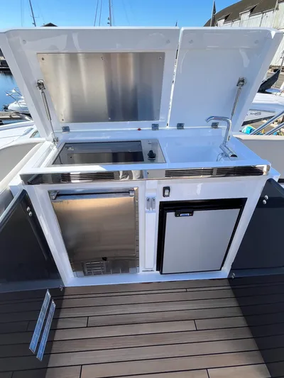  Yacht Photos Pics Outdoor kitchen on 2025 Fairline Squadron 50 yacht with grill and sink.