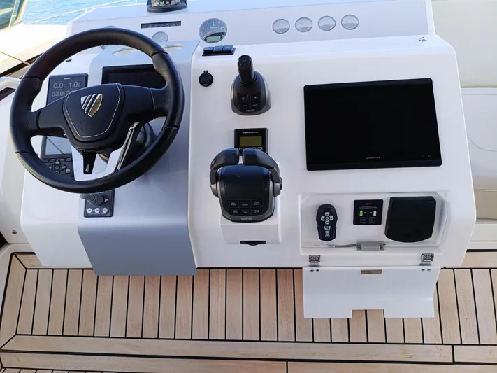  Yacht Photos Pics Helm of 2025 Fairline Squadron 50 yacht with modern controls and steering wheel.